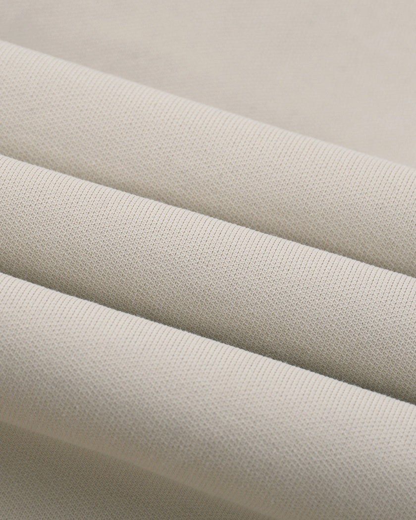 Detailed view of stretch cotton-blend fabric and stitching on Axis Bomber Jacket in Gray Camel