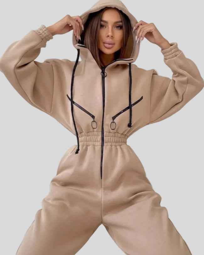Closeup of zip hoodie and elastic waist detail on Athlesi Balance Zip Jumpsuit in khaki