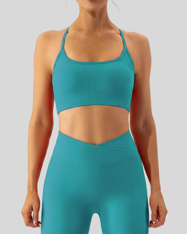 Minimal spaghetti strap sports bra in teal shown from the front