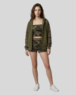 Full body front view of woman wearing Camo Accent Hoodie in army green with green camo hood and sleeves