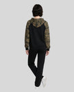 Full body back view of woman wearing Camo Accent Hoodie in black with green camo hood and sleeves