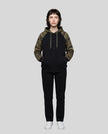 Full body front view of woman wearing Camo Accent Hoodie in black with green camo hood and sleeves
