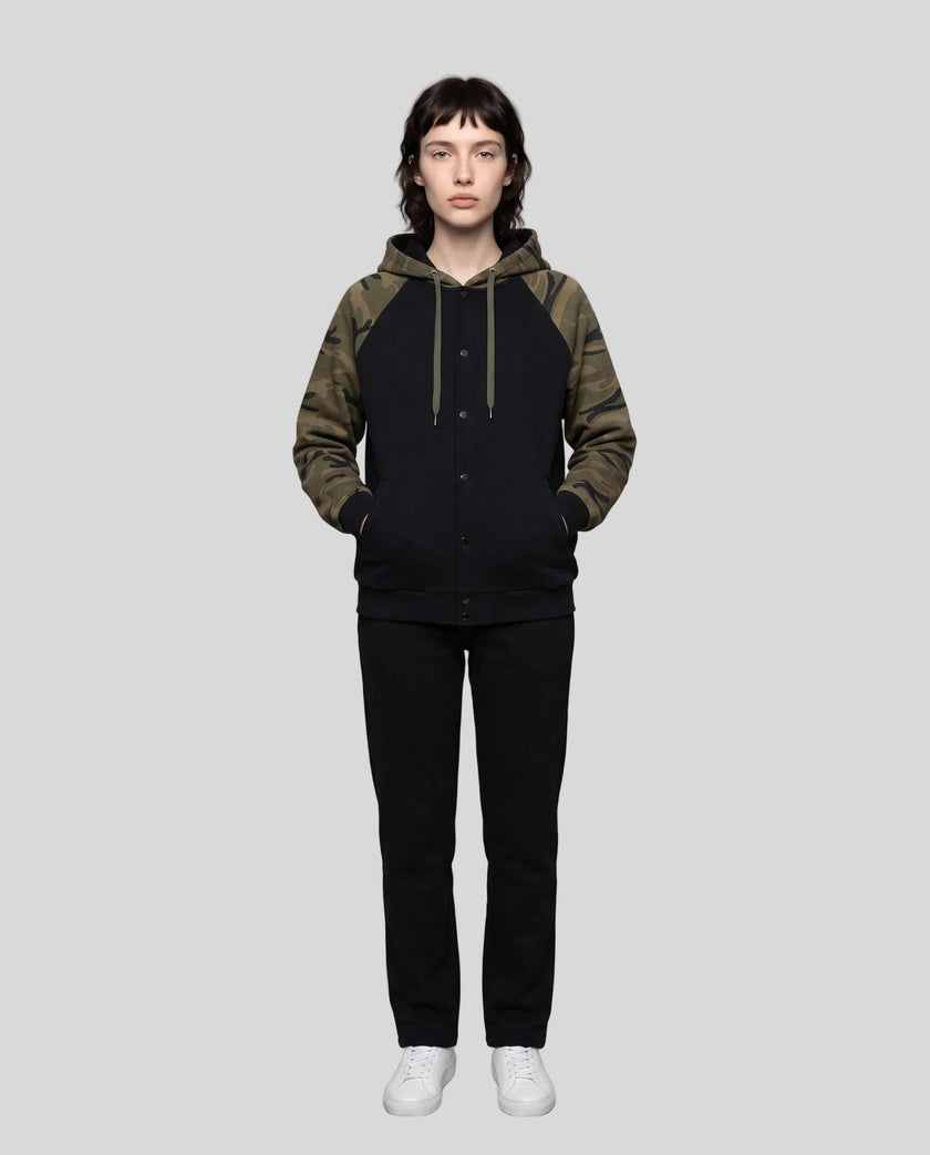 Full body front view of woman wearing Camo Accent Hoodie in black with green camo hood and sleeves