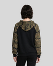 Mid body back view of woman wearing black Camo Accent Hoodie with green camo hood and sleeves