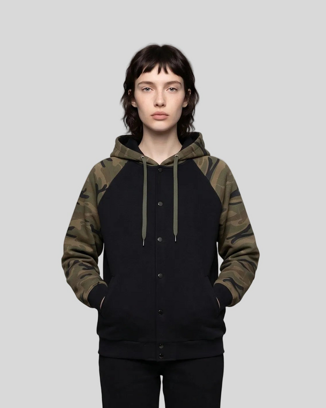 Mid body front view of woman wearing Camo Accent Hoodie in black with green camo sleeves