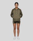 Full body front view of woman wearing Camo Accent Hoodie in khaki with green camo hood and sleeves