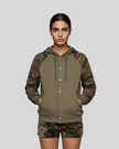Mid body front view of woman wearing Camo Accent Hoodie in khaki with green camo sleeves