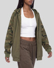 Upper body front view angle of woman wearing Camo Accent Hoodie in khaki with green camo sleeves