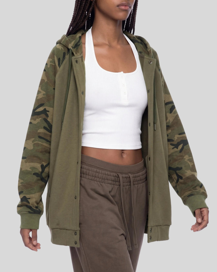 Upper body front view angle of woman wearing Camo Accent Hoodie in khaki with green camo sleeves