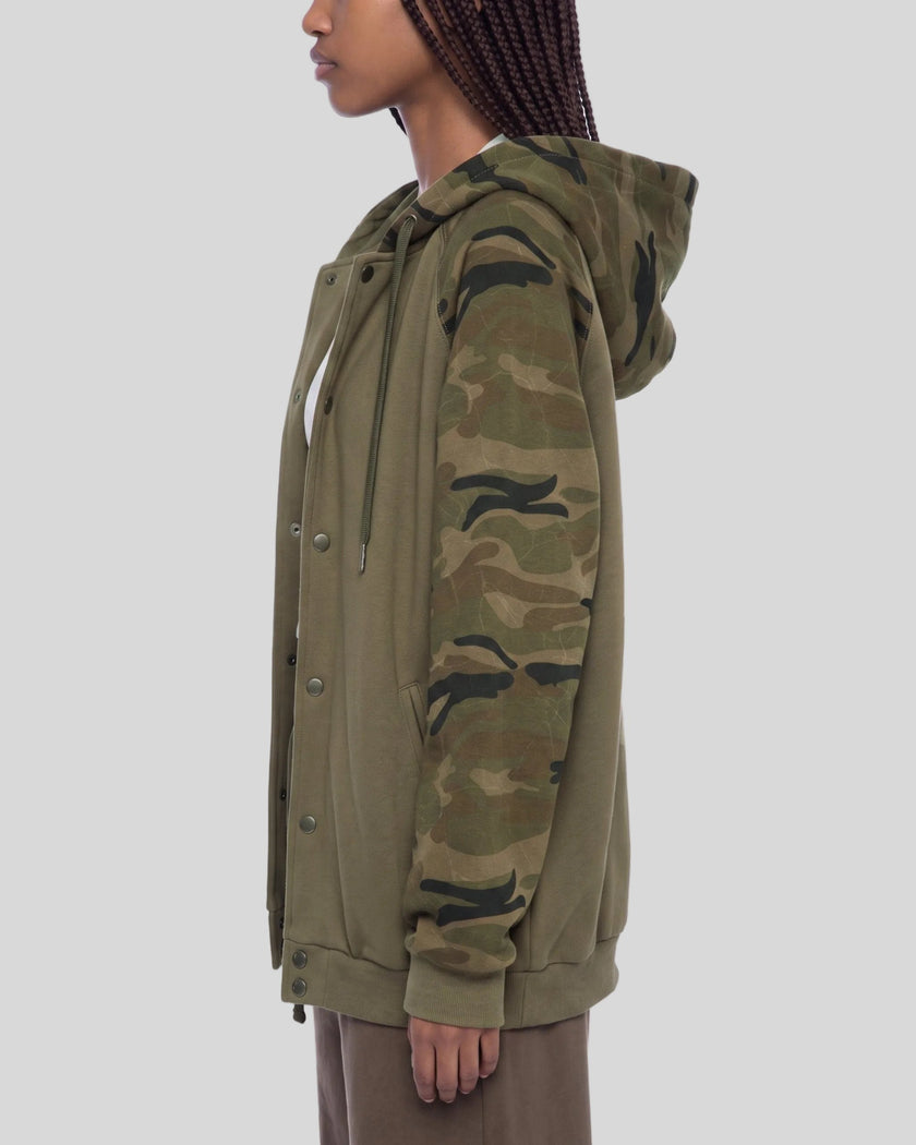 Upper body side view of woman wearing Camo Accent Hoodie in khaki with green camo sleeves