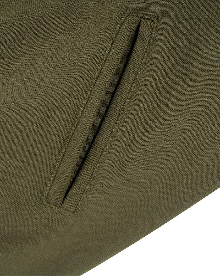 Closeup of functional front pockets on Camo Accent Hoodie in army green