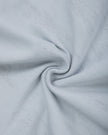 Interior fabric texture of the Light Blue Camo Off-Shoulder Crop Tee
