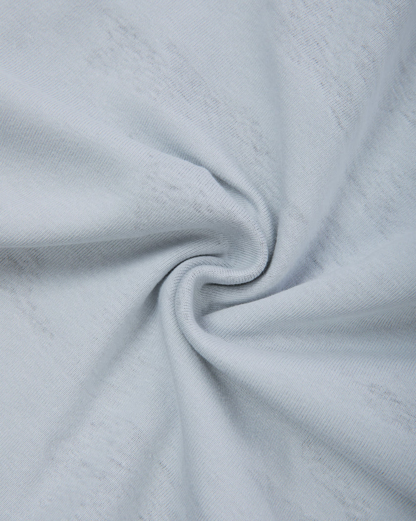 Interior fabric texture of the Light Blue Camo Off-Shoulder Crop Tee