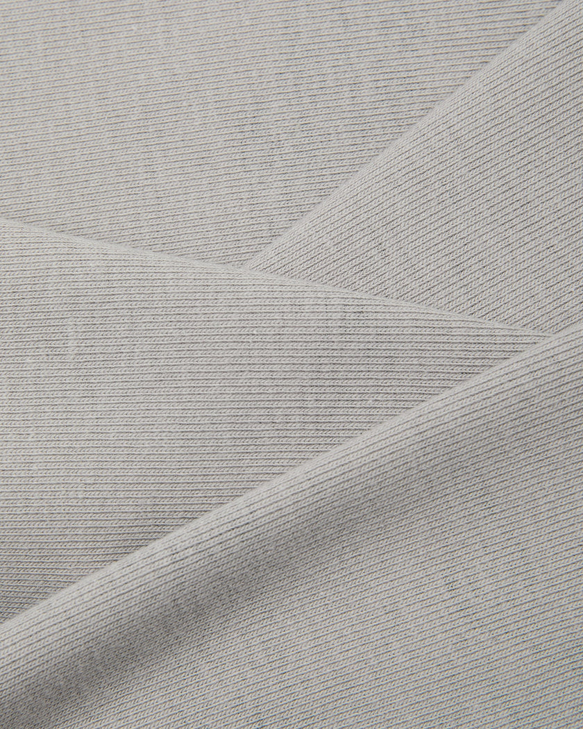A close-up of light blue Camo Tube Top fabric interior texture, folded diagonally to show the material's drape and texture.