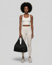 Model carrying CarryForm Studio Bag in black styled for gym and everyday use