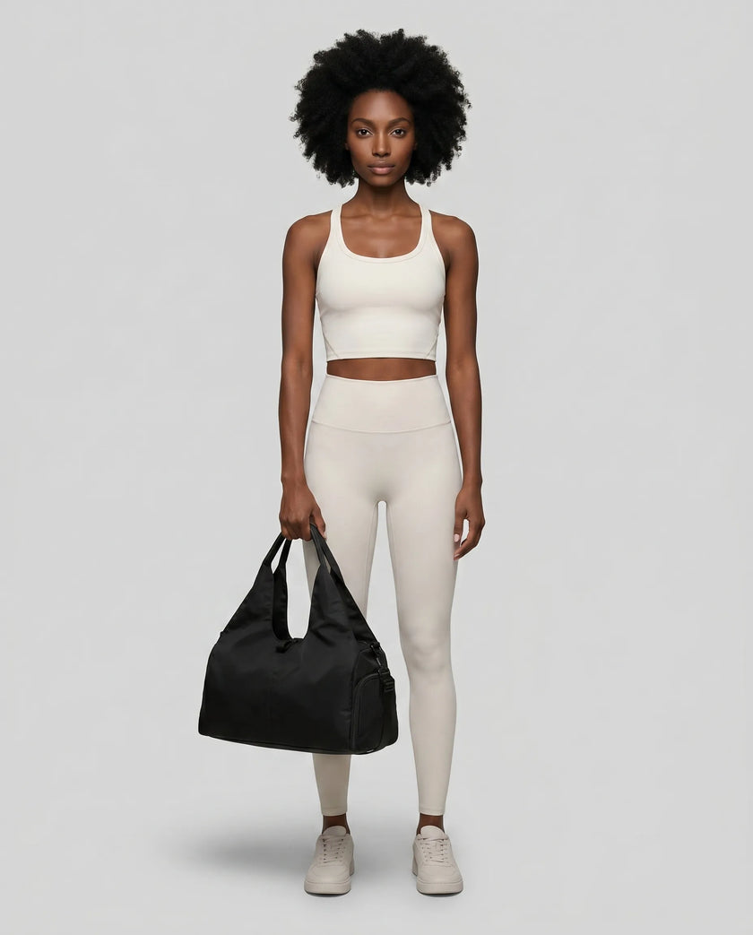 Model carrying CarryForm Studio Bag in black styled for gym and everyday use