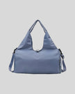 CarryForm Studio Bag in dusty blue front view with structured silhouette and soft handles