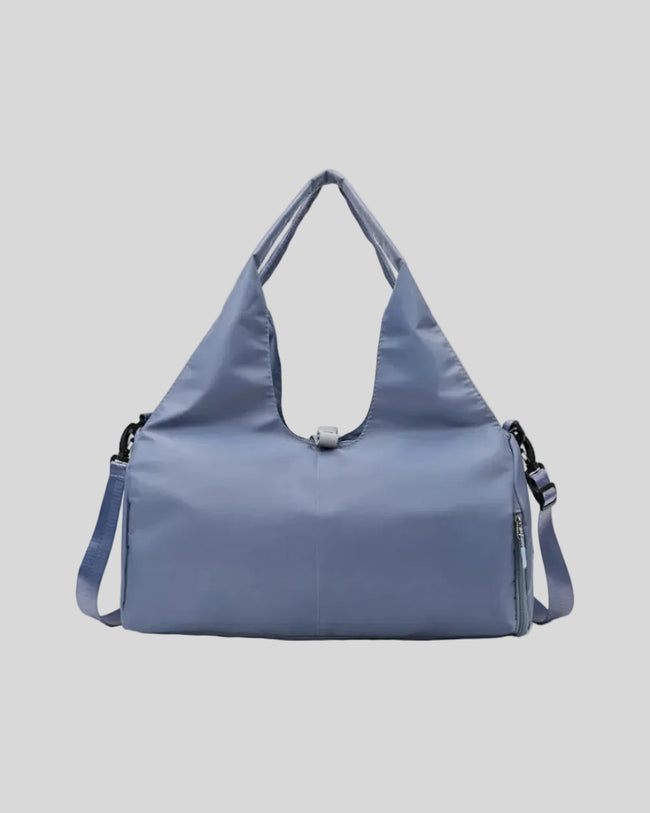 CarryForm Studio Bag in dusty blue front view with structured silhouette and soft handles