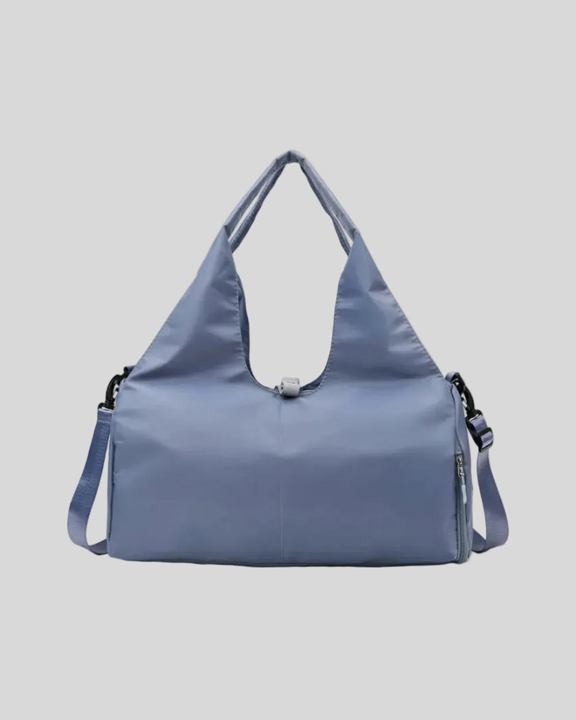 CarryForm Studio Bag in dusty blue front view with structured silhouette and soft handles