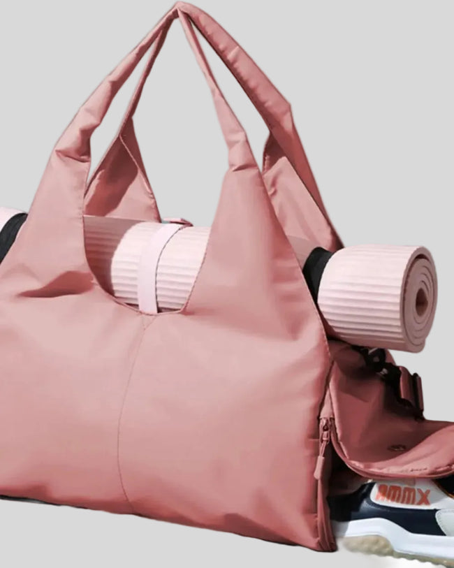 CarryForm Studio Bag full side view highlighting yoga mat carrying space, straps and spacious design
