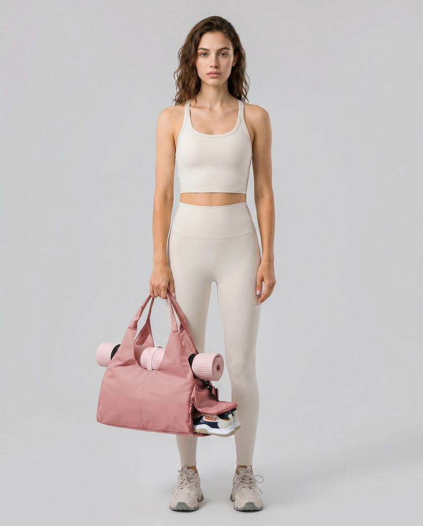 Model carrying CarryForm Studio Bag in dusty pink styled for gym and everyday use