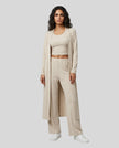 Woman wearing the CloudEase Lounge Set in beige front view with cropped tank wide-leg pants and long sleeve cover-up
