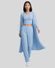 Woman wearing the CloudEase Lounge Set in light blue front view with cropped tank wide-leg pants and long sleeve cover-up