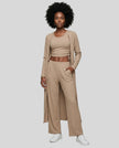 Woman wearing the CloudEase Lounge Set in tan front view with cropped tank wide-leg pants and long sleeve cover-up