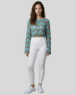 Front full-body view of the Athlesi ColorRush Wave Knit Top in light blue layered over an Athlesi sports bra and leggings