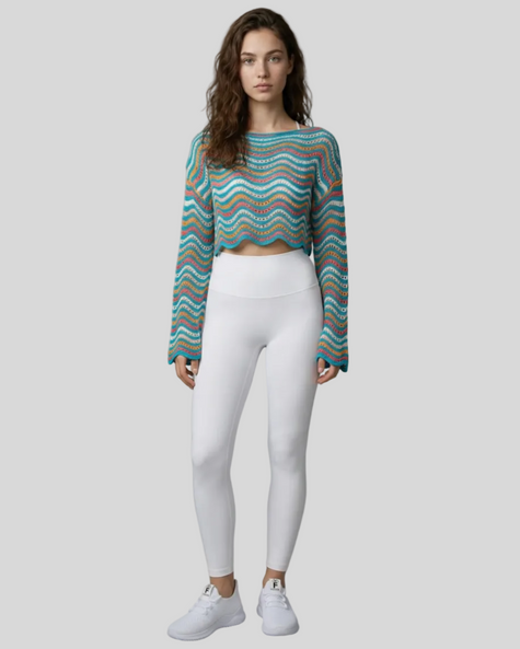 Front full-body view of the Athlesi ColorRush Wave Knit Top in light blue layered over an Athlesi sports bra and leggings