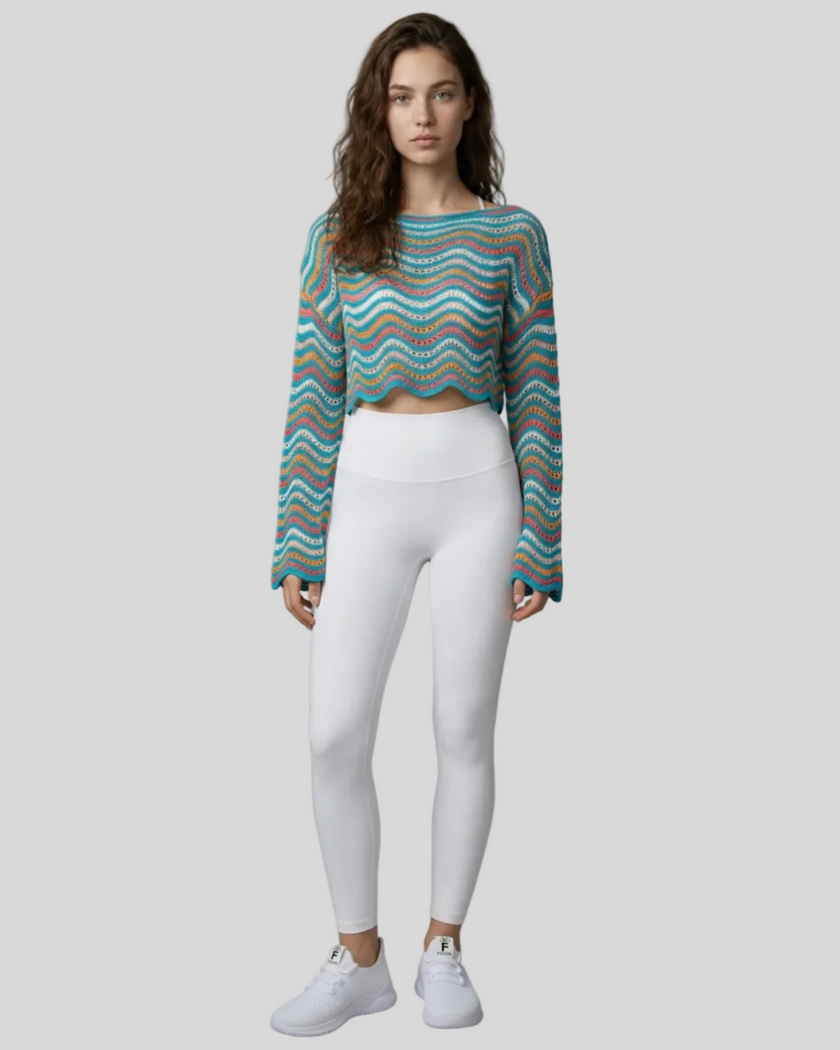 Front full-body view of the Athlesi ColorRush Wave Knit Top in light blue layered over an Athlesi sports bra and leggings