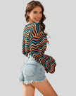 Side mid-body view of the Athlesi ColorRush Wave Knit Top highlighting cropped silhouette and knit drape in multicolor
