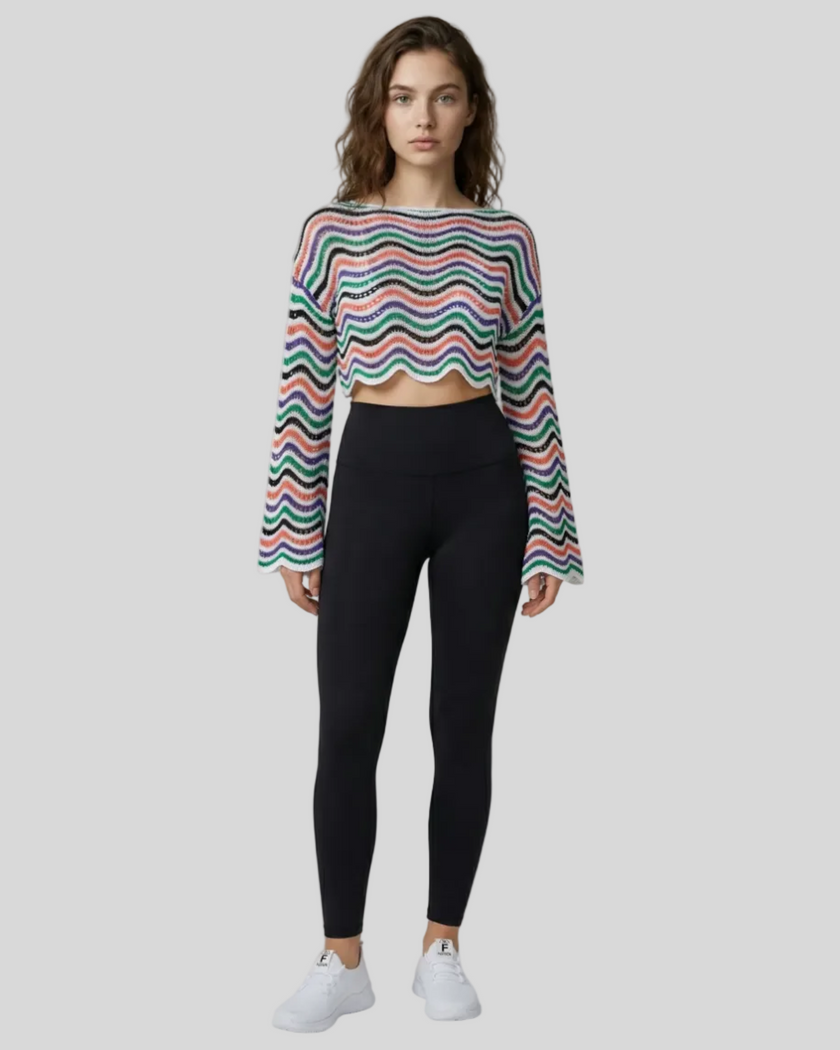 Front full-body view of the Athlesi ColorRush Wave Knit Top in white layered over an Athlesi sports bra and leggings