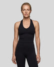 Model wearing the Contour Halter Yoga Tank Top in Black, front view