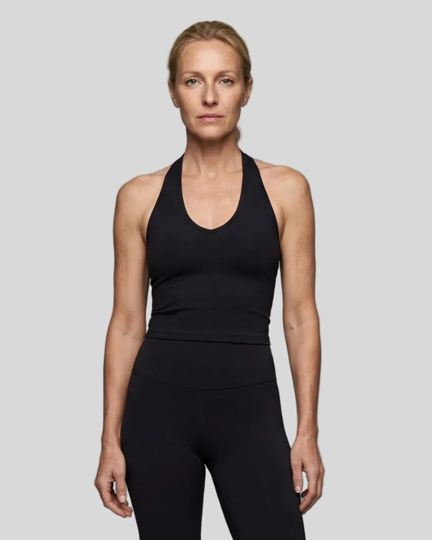 Model wearing the Contour Halter Yoga Tank Top in Black, front view