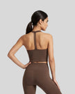 Back view of a model wearing the Contour Halter Yoga Tank Top in Brown