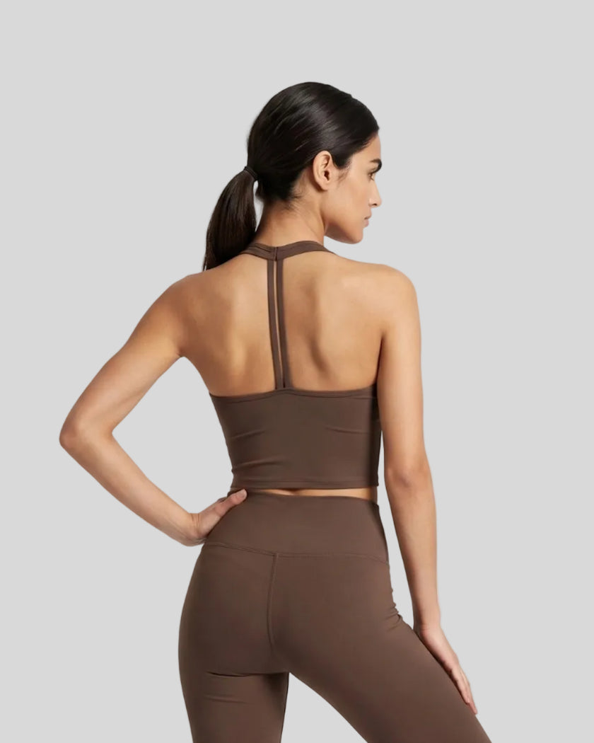 Back view of a model wearing the Contour Halter Yoga Tank Top in Brown