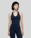 Model wearing the Contour Halter Yoga Tank Top in Navy Blue, front view