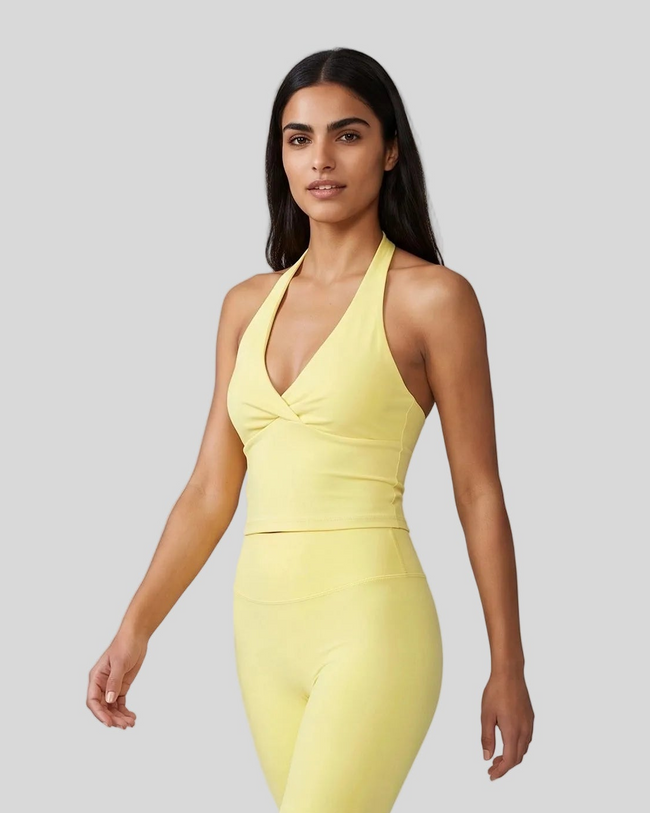 Angled front view showing the ruched crossover detail on Contour Ruched Yoga Top in yellow