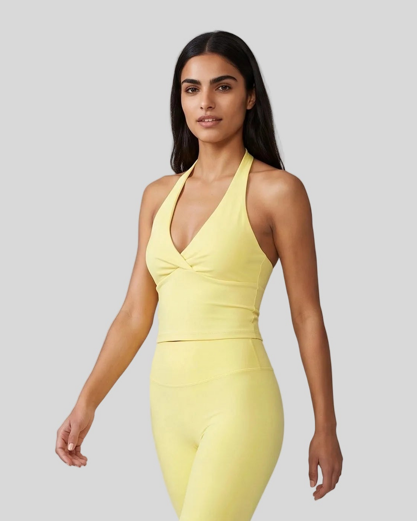 Angled front view showing the ruched crossover detail on Contour Ruched Yoga Top in yellow
