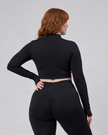 Mid body back view of woman wearing Contour Yoga Jacket in black