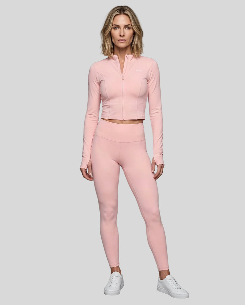 Full body front view of woman wearing Contour Yoga Jacket with matching pink activewear