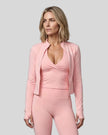 Mid body front view of woman wearing Contour Yoga Jacket in pink unzipped