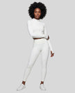 Full body front view of woman wearing zipped Contour Yoga Jacket with matching white activewear