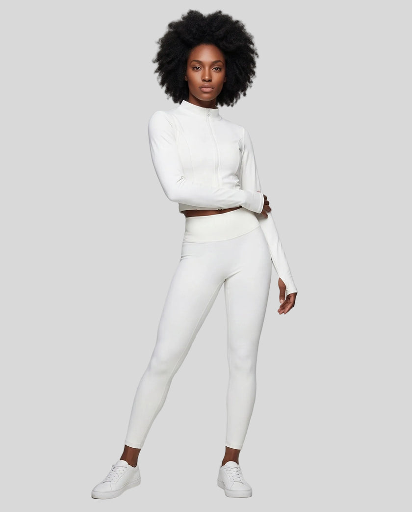 Full body front view of woman wearing zipped Contour Yoga Jacket with matching white activewear