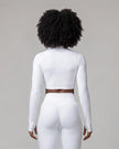 Mid body back view of woman wearing Contour Yoga Jacket in white