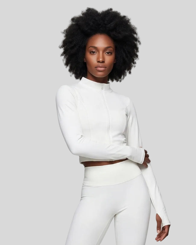 Mid body front view of woman wearing Contour Yoga Jacket in white fully zipped