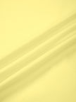 Closeup of smooth yellow nylon stretch fabric on Contour Yoga Jacket