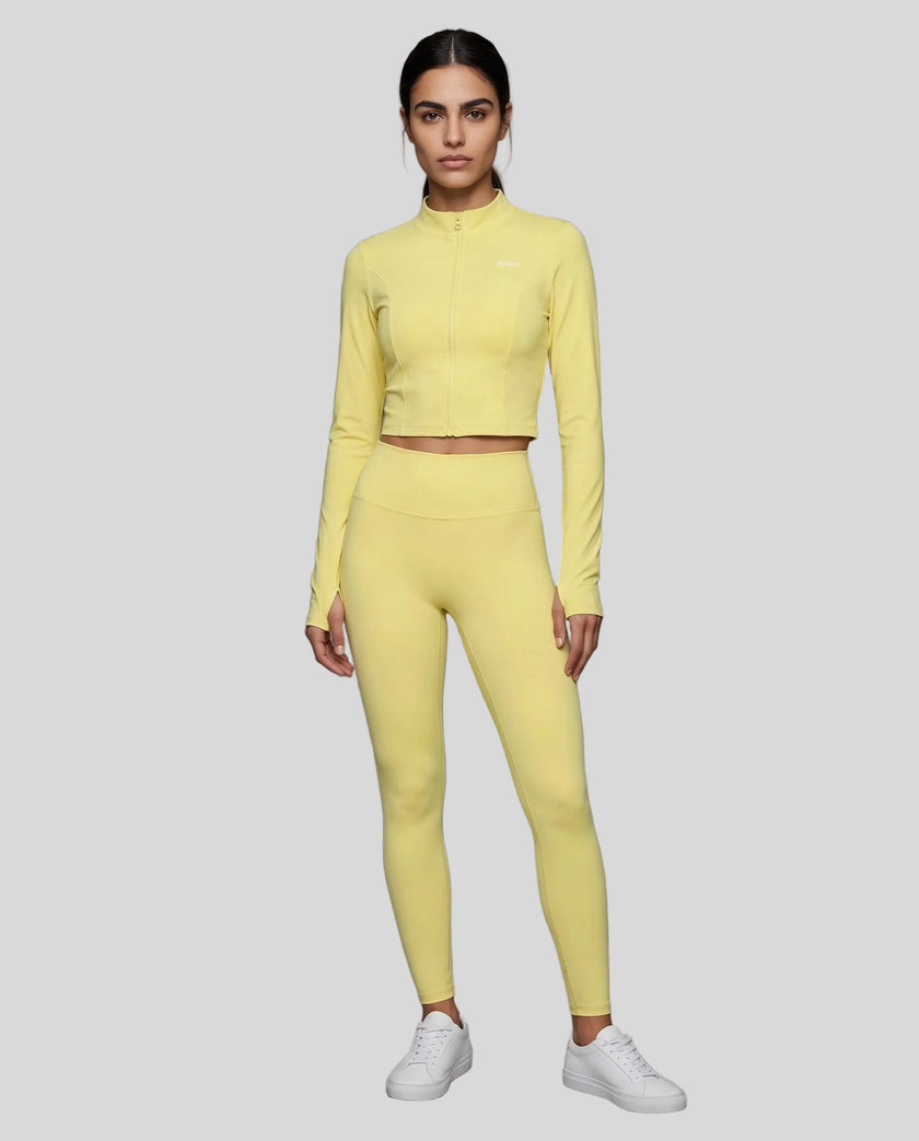 Full body front view of woman wearing zipped Contour Yoga Jacket with matching pink activewear