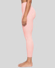 Lower body side view of woman wearing Contour Yoga Leggings in pink
